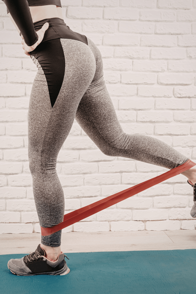 woman performing a glute exercise using a resistance band