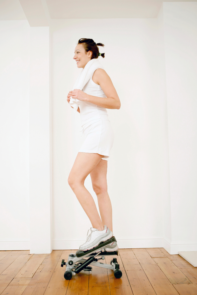 woman exercising on a low impact step strider