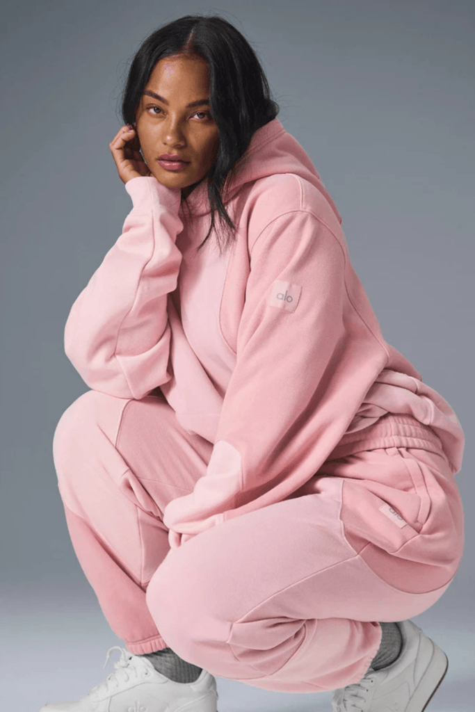 Woman wearing winter sweatpants and hoodie workout outfit for home training