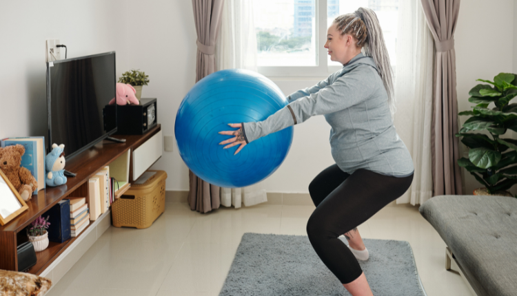 woman on stability ball doing a squat