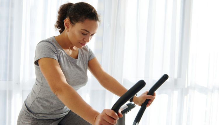 woman working out from home on a stationary bike