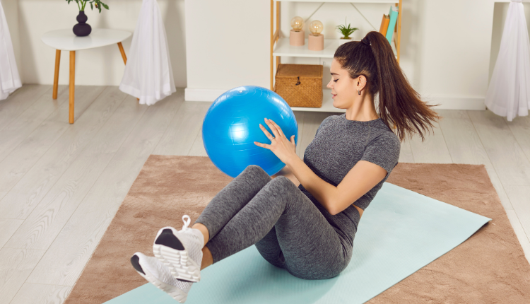 woman doing a Russian twist with a medicine ball