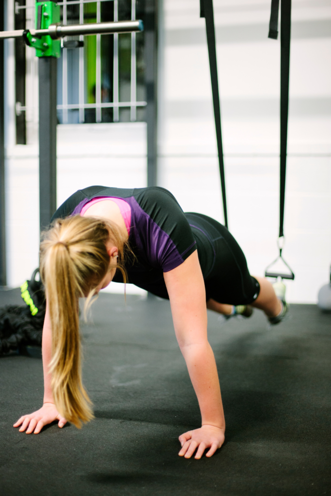 woman working out on n TRX suspension trainer